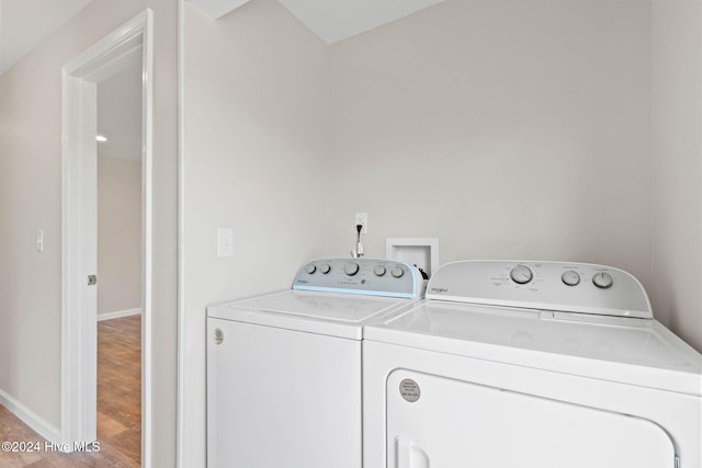 laundry room featuring washer and clothes dryer and light wood-type flooring