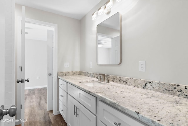 bathroom featuring hardwood / wood-style floors, vanity, and ceiling fan