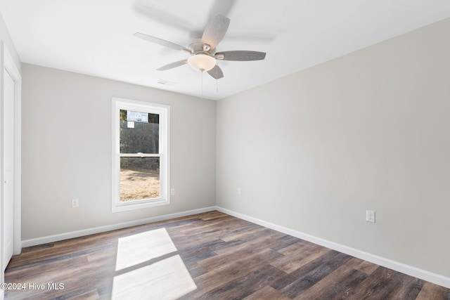 unfurnished room featuring dark hardwood / wood-style floors and ceiling fan