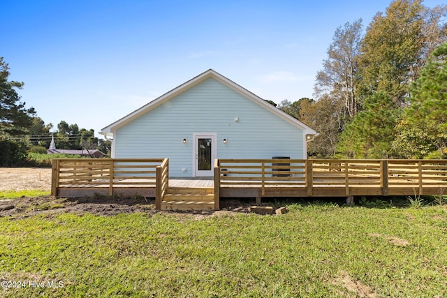 rear view of house with a yard and a wooden deck