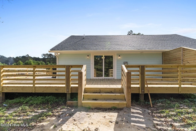 rear view of property with a wooden deck