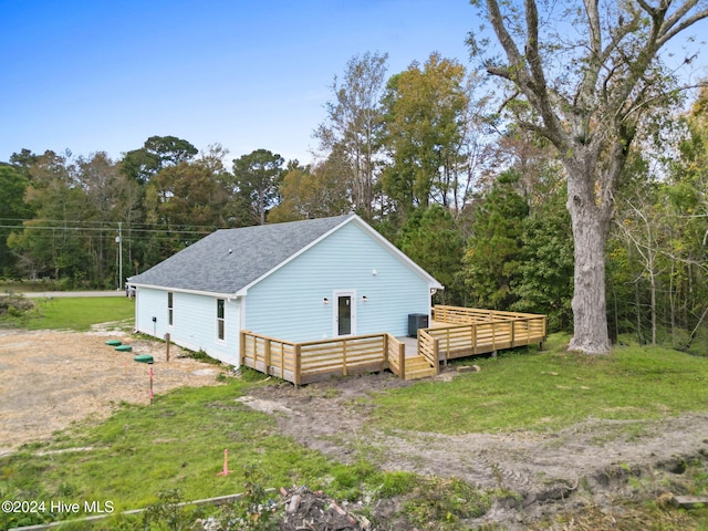 exterior space featuring a lawn, central AC, and a deck