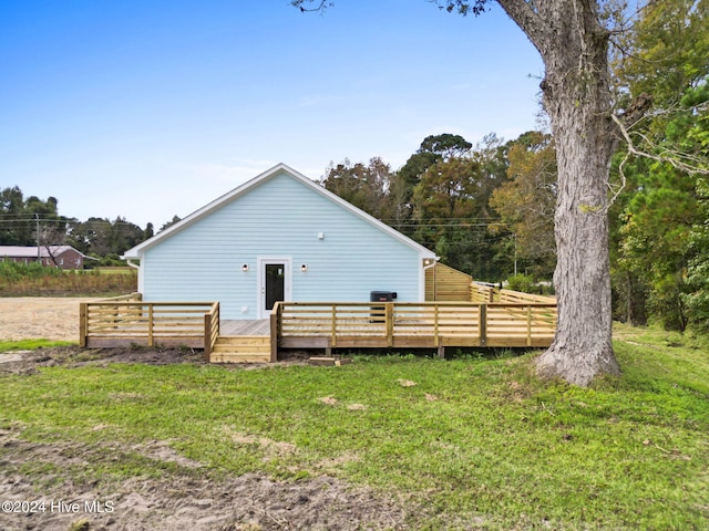 back of house with a lawn and a wooden deck