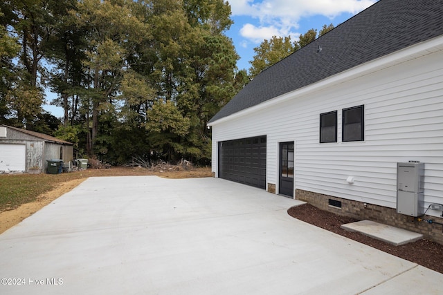 view of home's exterior featuring an outdoor structure and a garage