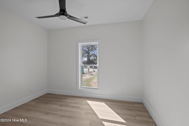 empty room featuring ceiling fan and light hardwood / wood-style flooring