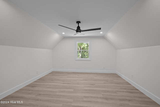 additional living space featuring light hardwood / wood-style flooring, ceiling fan, and lofted ceiling