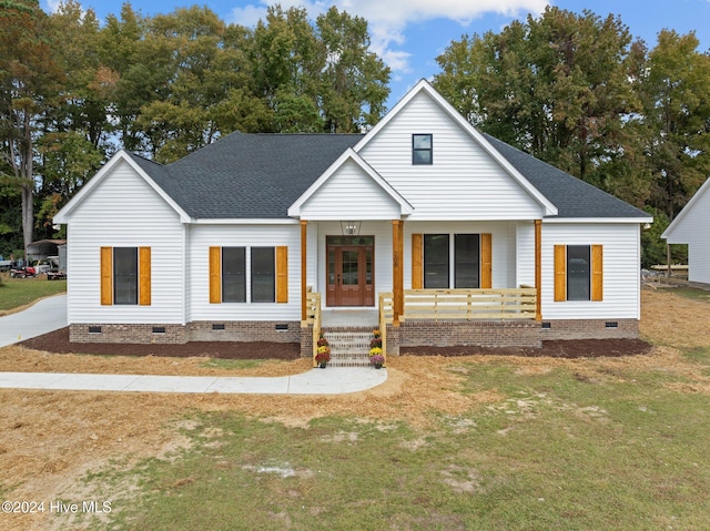 view of front of home with covered porch and a front yard