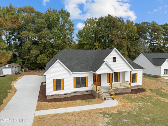 view of front of home featuring a porch and a front lawn