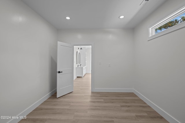 unfurnished room with light wood-type flooring