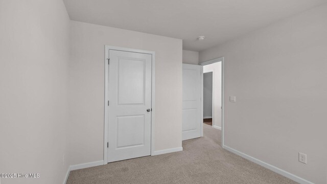 carpeted bedroom featuring a nursery area