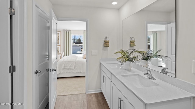 bathroom with vanity and hardwood / wood-style floors