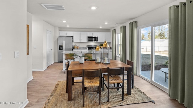 dining room with light wood-type flooring