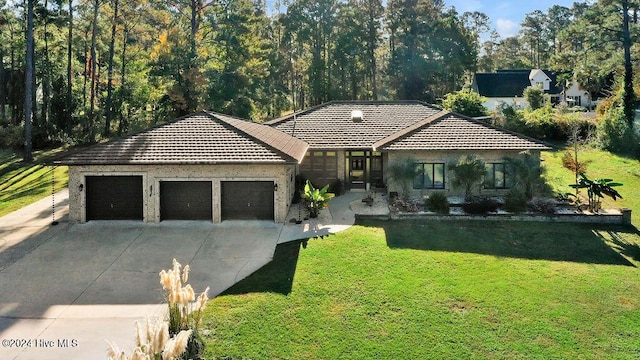 single story home featuring a garage and a front lawn