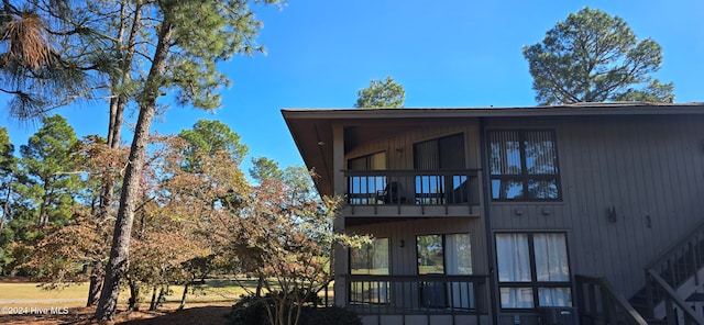 back of property featuring a balcony