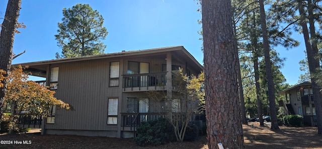 back of property with a balcony