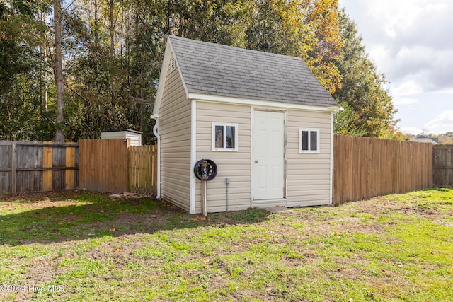 view of outbuilding with a lawn