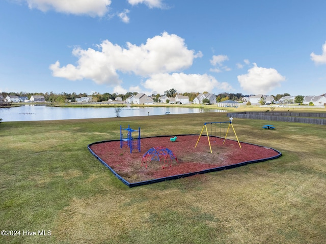 view of play area with a lawn and a water view