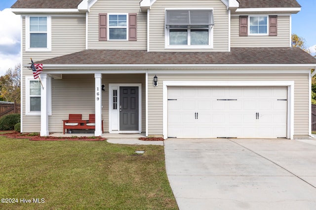 view of front facade featuring a front lawn, covered porch, and a garage