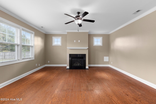 unfurnished living room featuring crown molding, hardwood / wood-style floors, ceiling fan, and a wealth of natural light