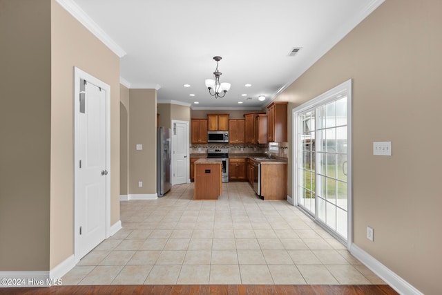 kitchen with a center island, stainless steel appliances, decorative light fixtures, crown molding, and an inviting chandelier