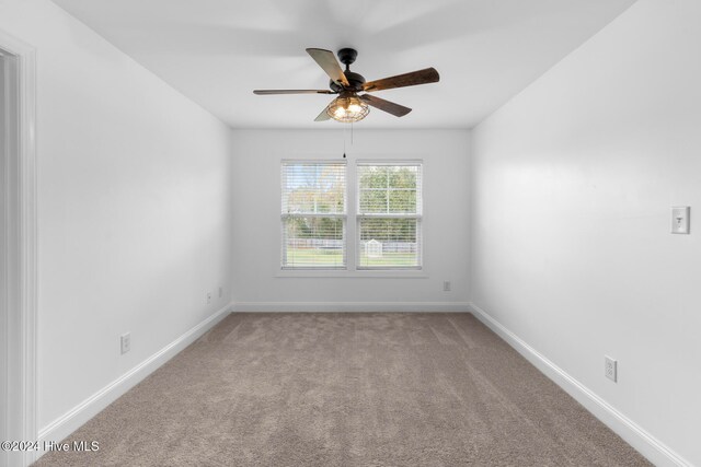 carpeted empty room featuring ceiling fan