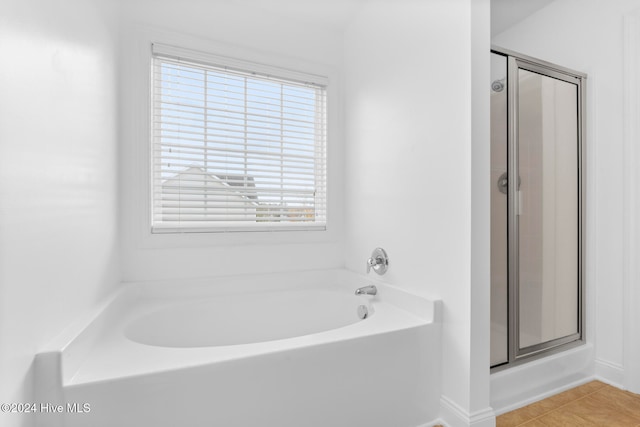 bathroom featuring independent shower and bath and tile patterned floors