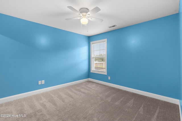 unfurnished room featuring ceiling fan and carpet floors