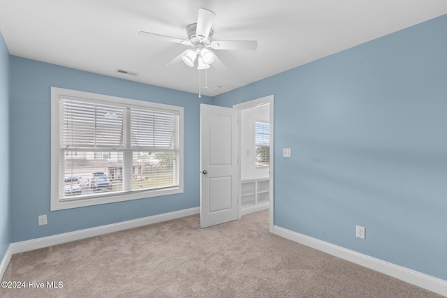 carpeted empty room with ceiling fan