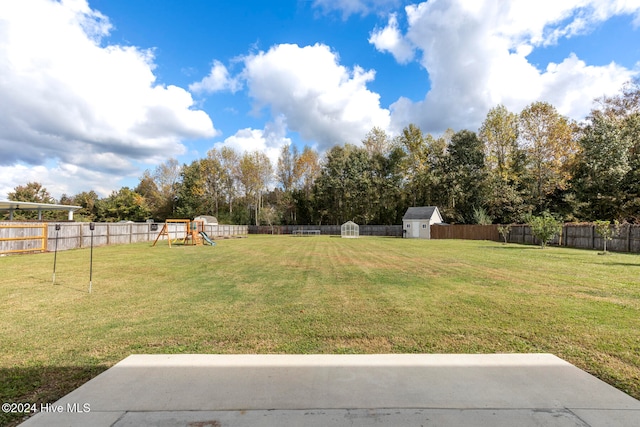 view of yard featuring a shed and a playground