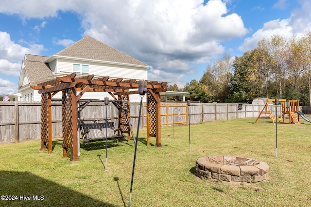 view of yard featuring a fire pit, a playground, and a pergola