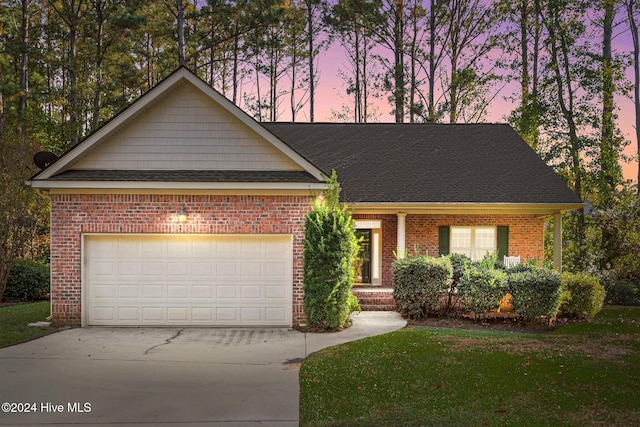 view of front of house featuring a lawn and a garage