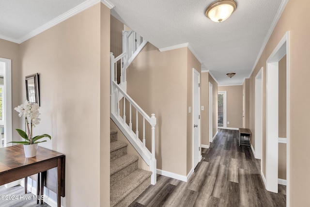 hall featuring a textured ceiling, dark hardwood / wood-style flooring, and ornamental molding