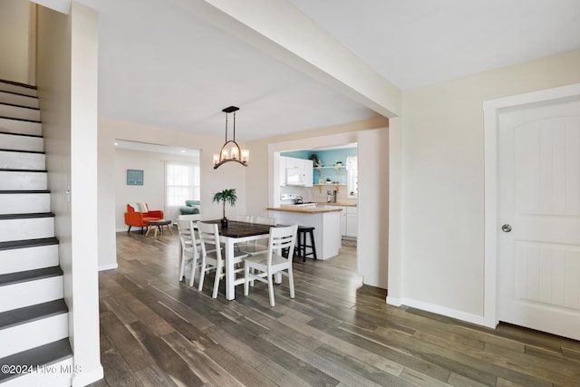 dining area featuring a chandelier and dark hardwood / wood-style flooring