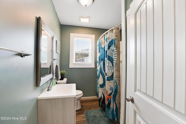 bathroom with toilet, hardwood / wood-style floors, vanity, and a shower with shower curtain