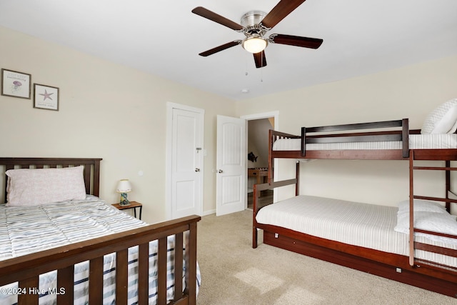 bedroom featuring light colored carpet and ceiling fan