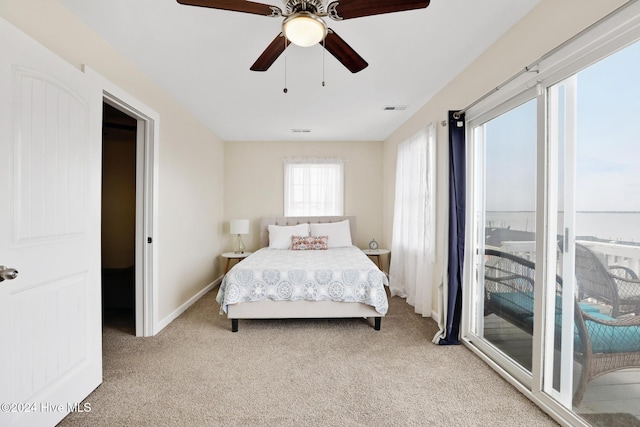 carpeted bedroom with ceiling fan and access to outside