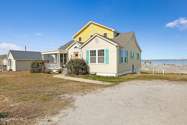 view of front of home with a water view and a porch