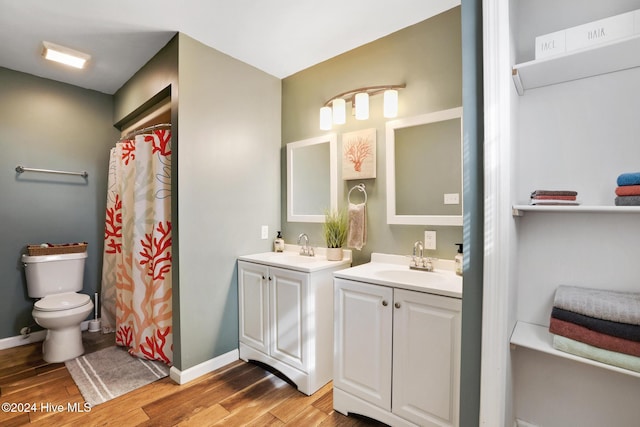 bathroom featuring vanity, toilet, walk in shower, and hardwood / wood-style floors