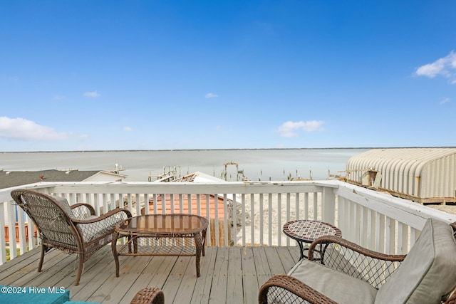 wooden deck featuring a water view