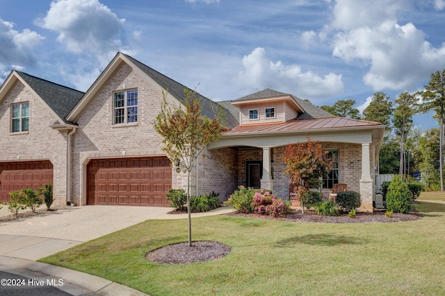 view of front facade featuring a garage, a front yard, and a porch