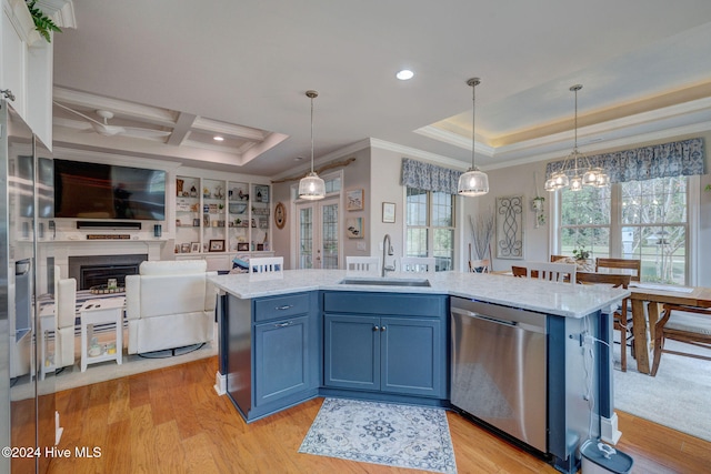 kitchen with blue cabinetry, decorative light fixtures, sink, light hardwood / wood-style floors, and dishwasher