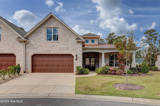 view of front of house featuring a front yard and a garage