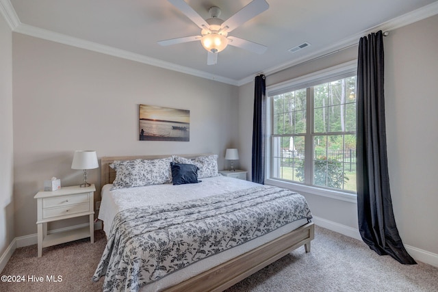 carpeted bedroom with ceiling fan and crown molding