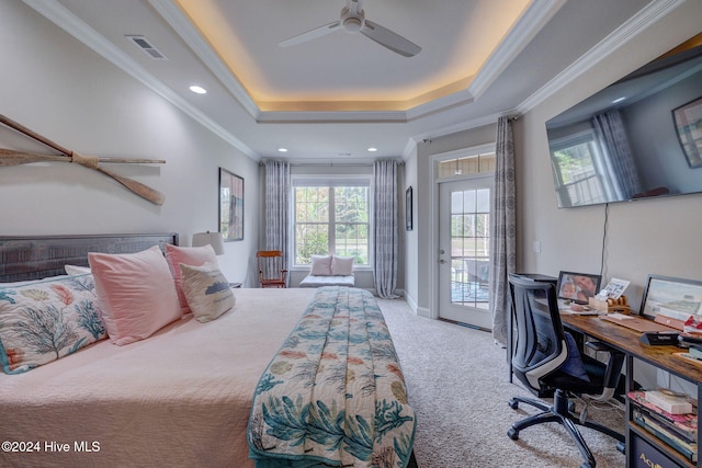 bedroom with ornamental molding, ceiling fan, access to exterior, a tray ceiling, and carpet floors