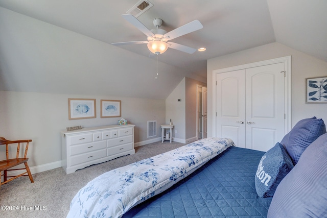 carpeted bedroom with lofted ceiling, ceiling fan, and a closet