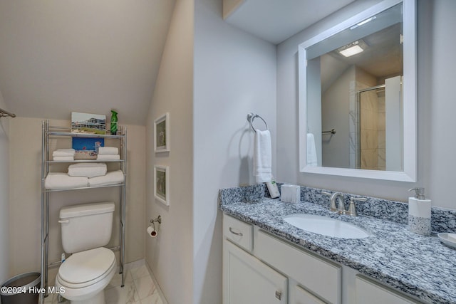 bathroom with vanity, toilet, a shower with door, and vaulted ceiling