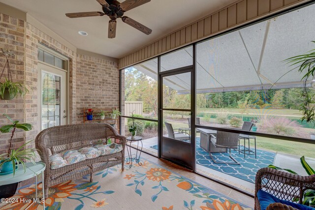 sunroom featuring ceiling fan