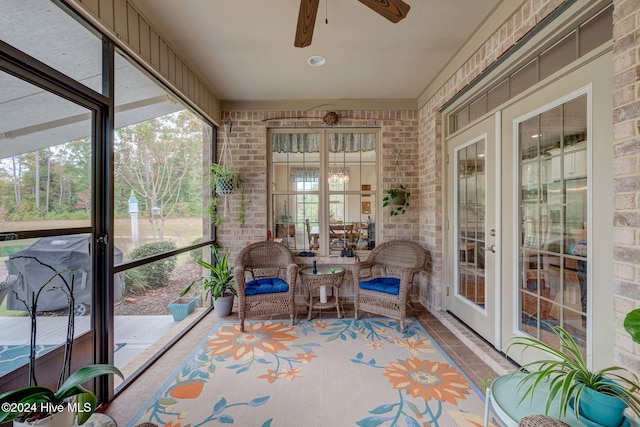 sunroom featuring ceiling fan