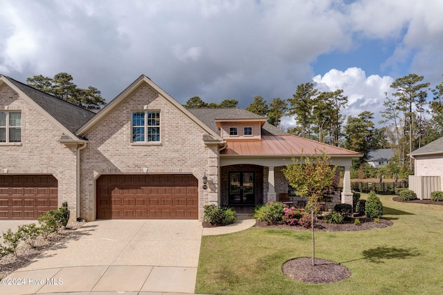 view of front facade featuring a garage and a front lawn