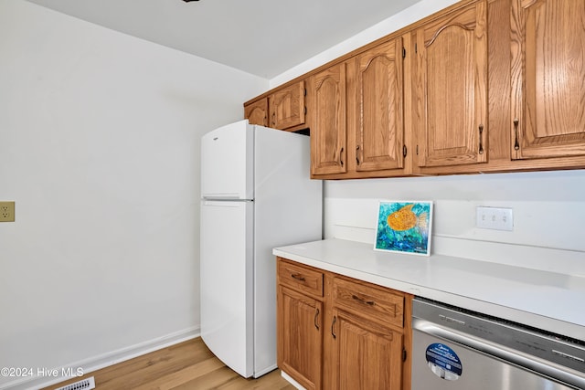 kitchen featuring dishwasher, white fridge, and light wood-type flooring